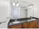 Bathroom featuring a large mirror over double sink vanity with granite countertop at 2108 Main Nw St, Atlanta, GA 30318