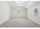 Spacious bedroom features neutral carpet and paint and includes two large windows at 2108 Main Nw St, Atlanta, GA 30318