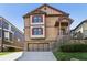 Two-story home featuring light brown siding, brick accents, and a two-car garage at 2108 Main Nw St, Atlanta, GA 30318