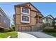 Two-story home with attached two-car garage, red shutters, and a well-maintained yard at 2108 Main Nw St, Atlanta, GA 30318