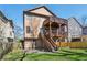 Back exterior of home featuring multi-level wood decks and a view of the landscaped yard at 2108 Main Nw St, Atlanta, GA 30318