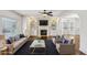 Staged living room with fireplace, built-in shelves and large windows allowing natural light at 2108 Main Nw St, Atlanta, GA 30318