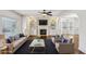 Staged living room features a fireplace, custom built-ins, and a large window at 2108 Main Nw St, Atlanta, GA 30318