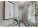 Hallway with decorative art and console, neutral walls, and decorative curtain at 5186 Longview Run, Decatur, GA 30035