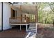 Back porch features wooden beams, brick accents, and stairs leading to the backyard at 6592 Factory Shoals Sw Rd, Mableton, GA 30126