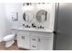 Modern bathroom features a double sink vanity, round mirrors, and updated fixtures, creating a stylish and functional space at 6592 Factory Shoals Sw Rd, Mableton, GA 30126