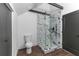 Modern bathroom features a marble tiled shower, glass door, and black hardware, creating a spa-like retreat at 6592 Factory Shoals Sw Rd, Mableton, GA 30126