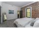 Comfortable bedroom with exposed brick wall, soft carpeting, and a view of the outdoors at 6592 Factory Shoals Sw Rd, Mableton, GA 30126