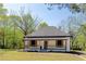 Charming single-story home featuring a covered front porch with wooden pillars and shutters, set in a lush green lawn at 6592 Factory Shoals Sw Rd, Mableton, GA 30126