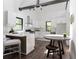 Bright, modern kitchen with white cabinets, stainless steel appliances, hardwood floors, and a breakfast bar area at 6592 Factory Shoals Sw Rd, Mableton, GA 30126