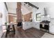 Open concept kitchen with an exposed brick wall, white cabinets, and stainless steel appliances, seamlessly connected to living space at 6592 Factory Shoals Sw Rd, Mableton, GA 30126