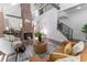 Spacious living room with exposed brick chimney, hardwood floors, modern staircase, and open concept design at 6592 Factory Shoals Sw Rd, Mableton, GA 30126