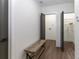 Mudroom features a wood bench and access to a laundry room and a storage room with wire shelves at 6592 Factory Shoals Sw Rd, Mableton, GA 30126
