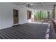 Spacious outdoor porch with wooden floors, railings, and a painted brick wall on this charming residence at 6592 Factory Shoals Sw Rd, Mableton, GA 30126