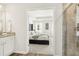 En-suite bathroom with granite countertops, shower stall, and view into main bedroom at 2014 Wyndham Pl, Conyers, GA 30013