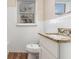 Clean bathroom with white tiles, a granite vanity, a toilet, and a window for natural light at 2203 Knoll Dr, Decatur, GA 30032