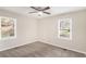 Comfortable bedroom featuring neutral walls, plush carpeting, and dual windows at 2203 Knoll Dr, Decatur, GA 30032