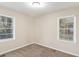 Inviting bedroom featuring neutral walls, plush carpeting, and natural light from two windows at 2203 Knoll Dr, Decatur, GA 30032