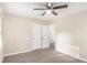 Bright bedroom boasting neutral paint, soft carpet, and a ceiling fan for added comfort at 2203 Knoll Dr, Decatur, GA 30032