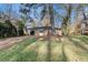 Street view of a quaint brick home with a bright red door, set on a grassy lot with mature trees at 2203 Knoll Dr, Decatur, GA 30032
