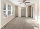 Inviting living room with neutral carpeting, a ceiling fan, and plenty of natural light from the window at 2203 Knoll Dr, Decatur, GA 30032
