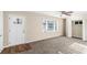 Bright living room featuring neutral carpet, a ceiling fan, and a large window for ample natural light at 2203 Knoll Dr, Decatur, GA 30032