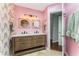 Bright bathroom features a double vanity, decorative wallpaper, and modern lighting for a luxurious feel at 244 13Th Ne St # 302, Atlanta, GA 30309