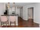 Bright kitchen with stone countertops, stainless appliances, and bar seating with modern pendant lighting at 244 13Th Ne St # 302, Atlanta, GA 30309