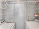 Functional laundry room with washer, dryer, and organized shelving, providing convenient space for laundry needs at 244 13Th Ne St # 302, Atlanta, GA 30309