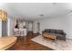 Living room leading into the kitchen with hardwood floors and a cozy sofa and kitchen barstools at 244 13Th Ne St # 302, Atlanta, GA 30309