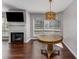 Living room with a fireplace, mounted TV, hardwood floors and an unique decorative light fixture at 244 13Th Ne St # 302, Atlanta, GA 30309