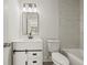 Bathroom featuring a sleek vanity, framed mirror, and shower with marble-look tiling at 3165 Dogwood Dr # 107, Hapeville, GA 30354