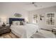 Bright bedroom featuring a blue headboard, neutral walls, and modern ceiling fan at 3165 Dogwood Dr # 107, Hapeville, GA 30354