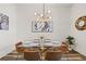 Dining area features modern lighting fixture, glass table, comfortable seating, and contemporary art at 3165 Dogwood Dr # 107, Hapeville, GA 30354