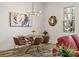 Bright dining room features a glass table, seating for six, modern lighting and contemporary art at 3165 Dogwood Dr # 107, Hapeville, GA 30354