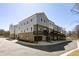 New townhome exterior featuring private garages, dark trim, light gray siding, and ample parking at 3165 Dogwood Dr # 107, Hapeville, GA 30354