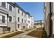 A street view between townhomes featuring brick and siding facades with landscaped islands at 3165 Dogwood Dr # 107, Hapeville, GA 30354