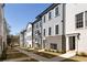 Street view of newly constructed townhomes featuring gray siding, brick accents, and manicured landscaping at 3165 Dogwood Dr # 107, Hapeville, GA 30354