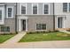 Up close, street view of new townhome exterior featuring gray brick and light siding, with dark door and trim at 3165 Dogwood Dr # 107, Hapeville, GA 30354