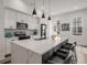 Modern kitchen with white cabinets, stainless appliances, quartz countertops, and pendant lighting at 3165 Dogwood Dr # 107, Hapeville, GA 30354