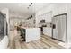 Bright, open kitchen with white cabinets, stainless appliances, quartz countertops, and hardwood floors at 3165 Dogwood Dr # 107, Hapeville, GA 30354