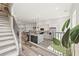 Modern white kitchen featuring an island with bar seating, stainless appliances, and wood floors at 3165 Dogwood Dr # 107, Hapeville, GA 30354