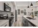 Sleek kitchen with white cabinets, black hardware, stainless appliances, and quartz countertops at 3165 Dogwood Dr # 107, Hapeville, GA 30354