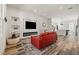 Bright living room with wood floors, modern fireplace, and comfortable red couch at 3165 Dogwood Dr # 107, Hapeville, GA 30354