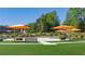 Beautiful community park featuring picnic benches, tables, green space, and colorful umbrellas for relaxing outdoors at 3165 Dogwood Dr # 107, Hapeville, GA 30354