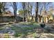 The backyard has a charming swing set and natural landscaping, creating a tranquil outdoor space at 6784 Tilton Ln, Peachtree Corners, GA 30360