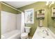 Cozy bathroom with a tub, toilet, and a clean white sink with cabinet space below at 6784 Tilton Ln, Peachtree Corners, GA 30360