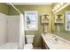 Cozy bathroom with a tub, toilet, and a clean white sink with cabinet space below at 6784 Tilton Ln, Peachtree Corners, GA 30360