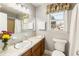 Bright bathroom offers a classic vanity and a window, enhanced by floral accents at 6784 Tilton Ln, Peachtree Corners, GA 30360