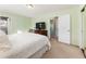 Bedroom features a comfortable bed, carpet, a view to the outside and access to a bathroom at 6784 Tilton Ln, Peachtree Corners, GA 30360